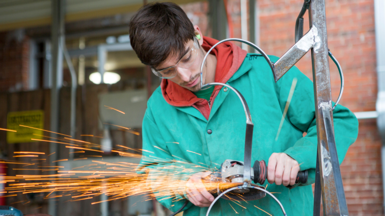 Sculpture student working with metal