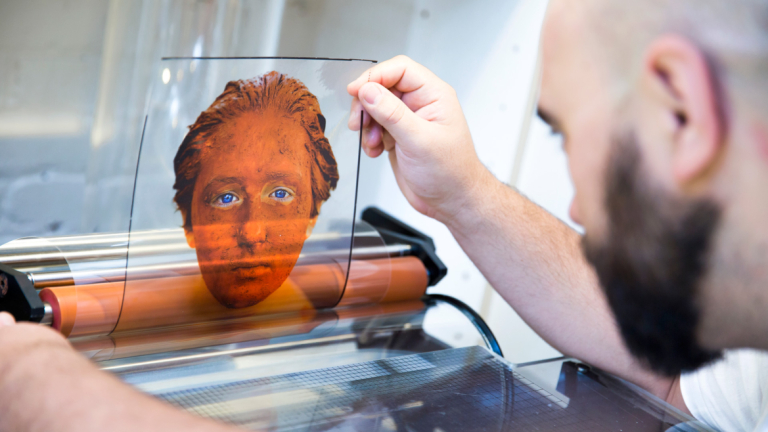 Photography student using drum scanner Photography student scanning color transparency