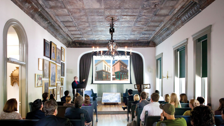 Preservation design student giving presentation in chapel of Clarence Thomas Center