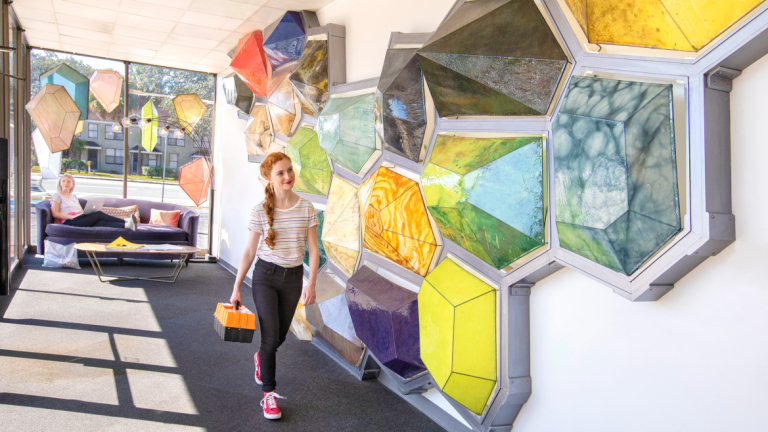 Student walking through Fahm Hall lobby