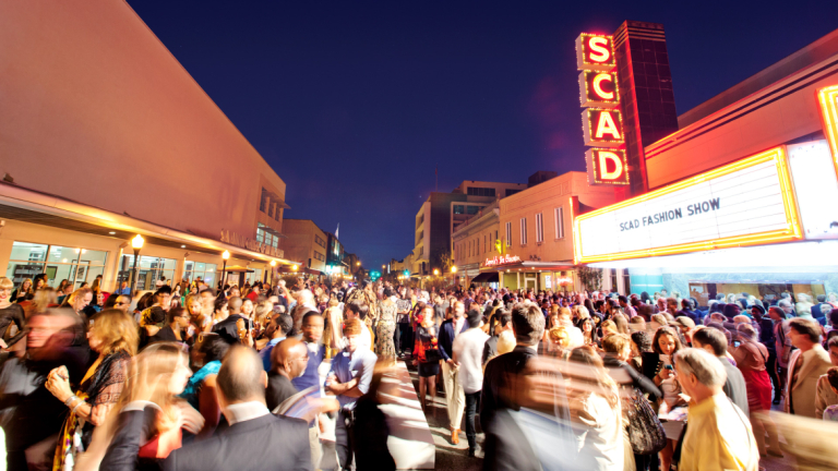 Event attendees gathering outside Trustees Theater