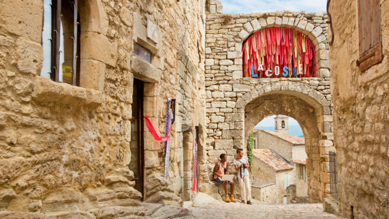 Students have a conversation in the cobbled streets of Lacoste, France
