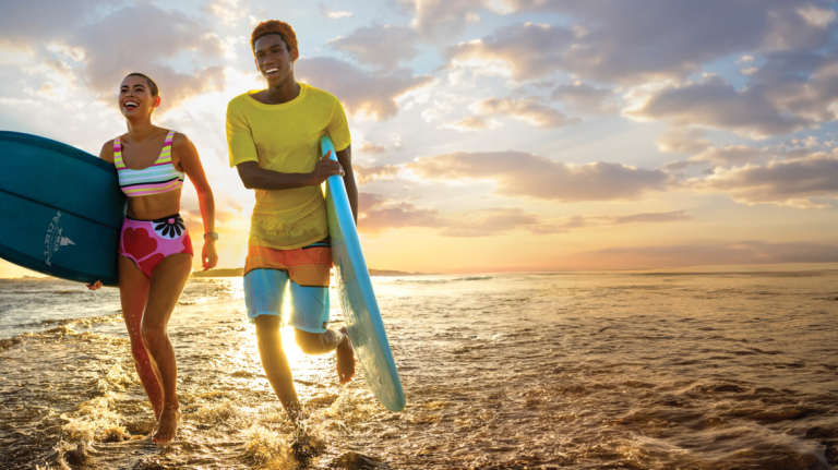 students running through beach surf
