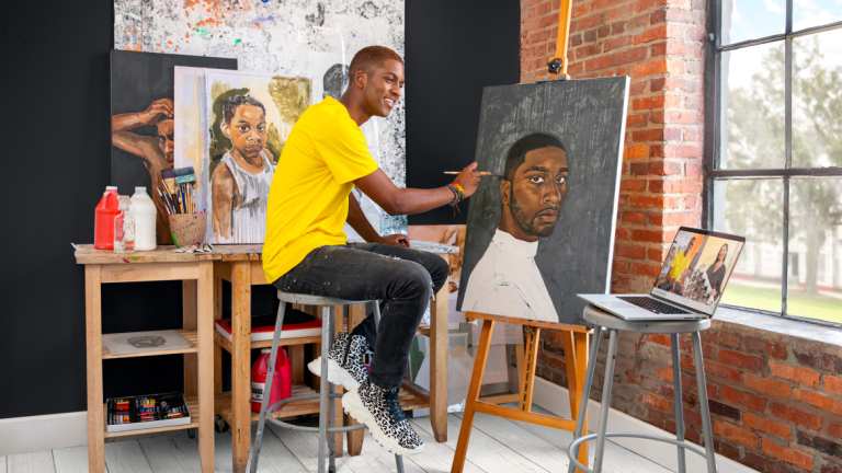 Painting student sitting at easel