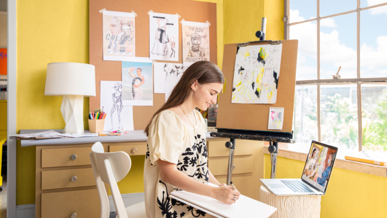Fashion student sketching in room