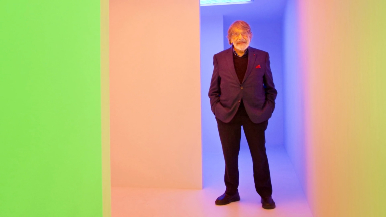 Carlos Cruz-Diez in front of large stripes of color 