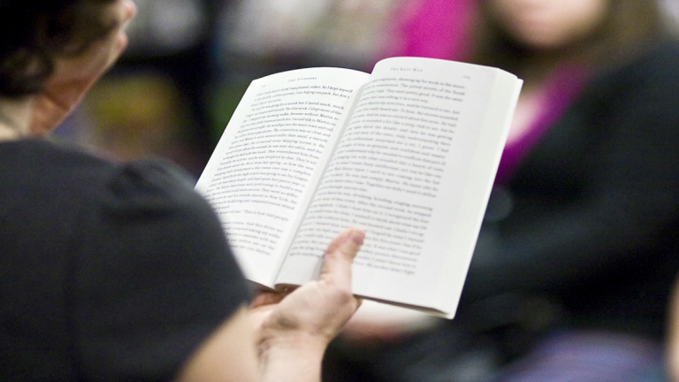 Person holds open book
