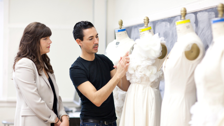 Fashion mentor Christian Cota critiquing student designs Fashion mentor Christian Cota critiquing student designs