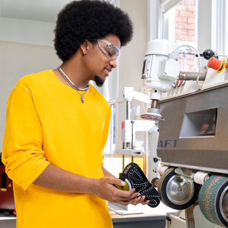 SCAD accessory design student uses tool to construct footwear