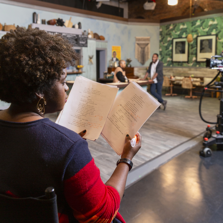 Dramatic writing student works on set