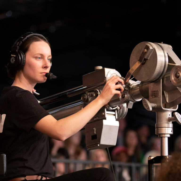Film and television student works a camera on the set of G.R.I.T.S.