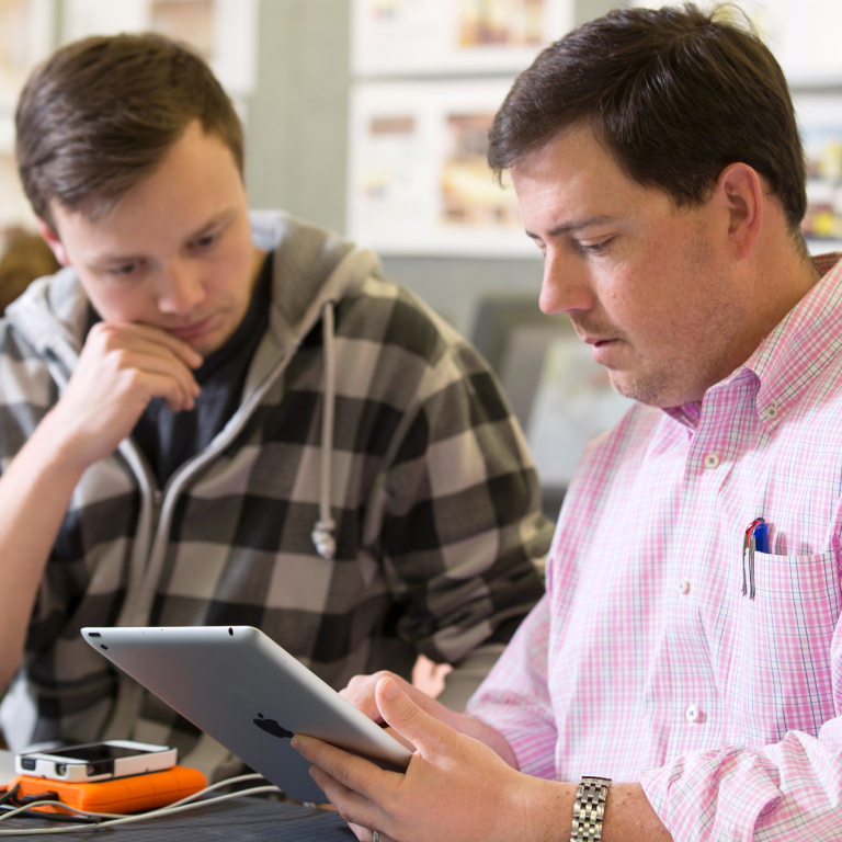 SCAD professor advising student SCAD professor reviewing work with student