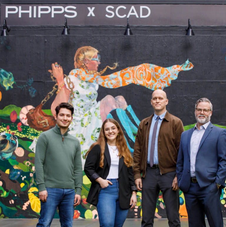 SCADpro students and faculty in front of Phipps Plaza mural