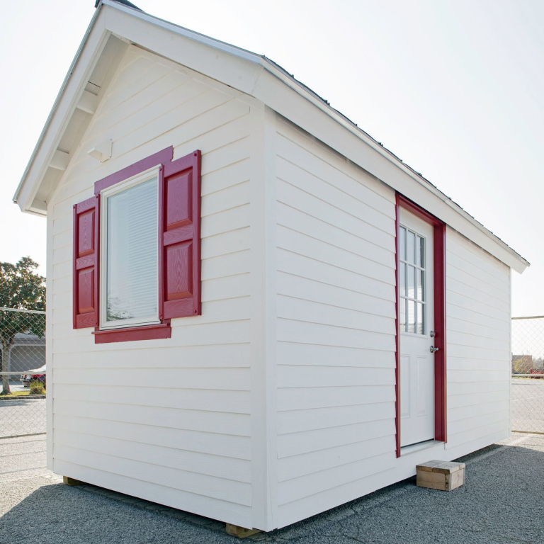 White tiny home with red trim