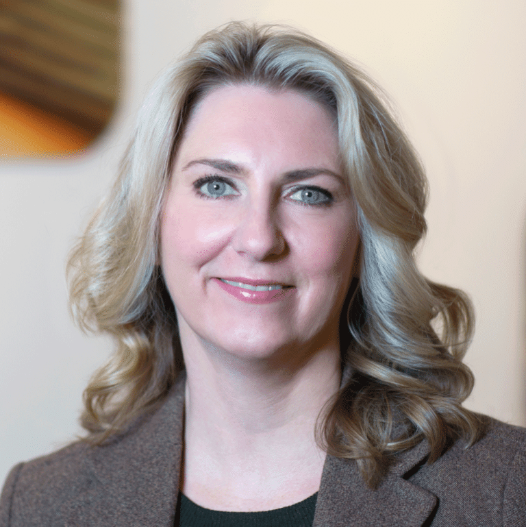 Angela Brandt in brown blazer