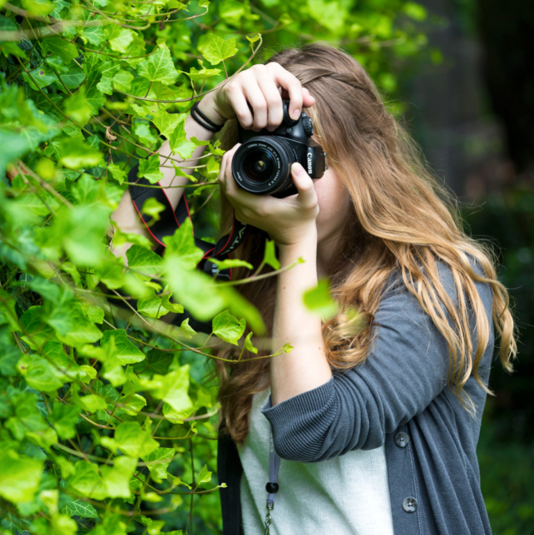 Pre-college student photographing outside