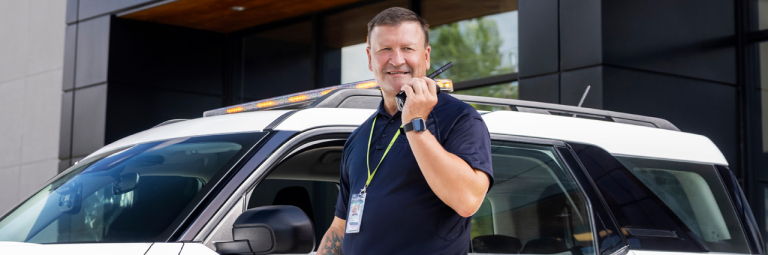 SCAD University security in front of vehicle.