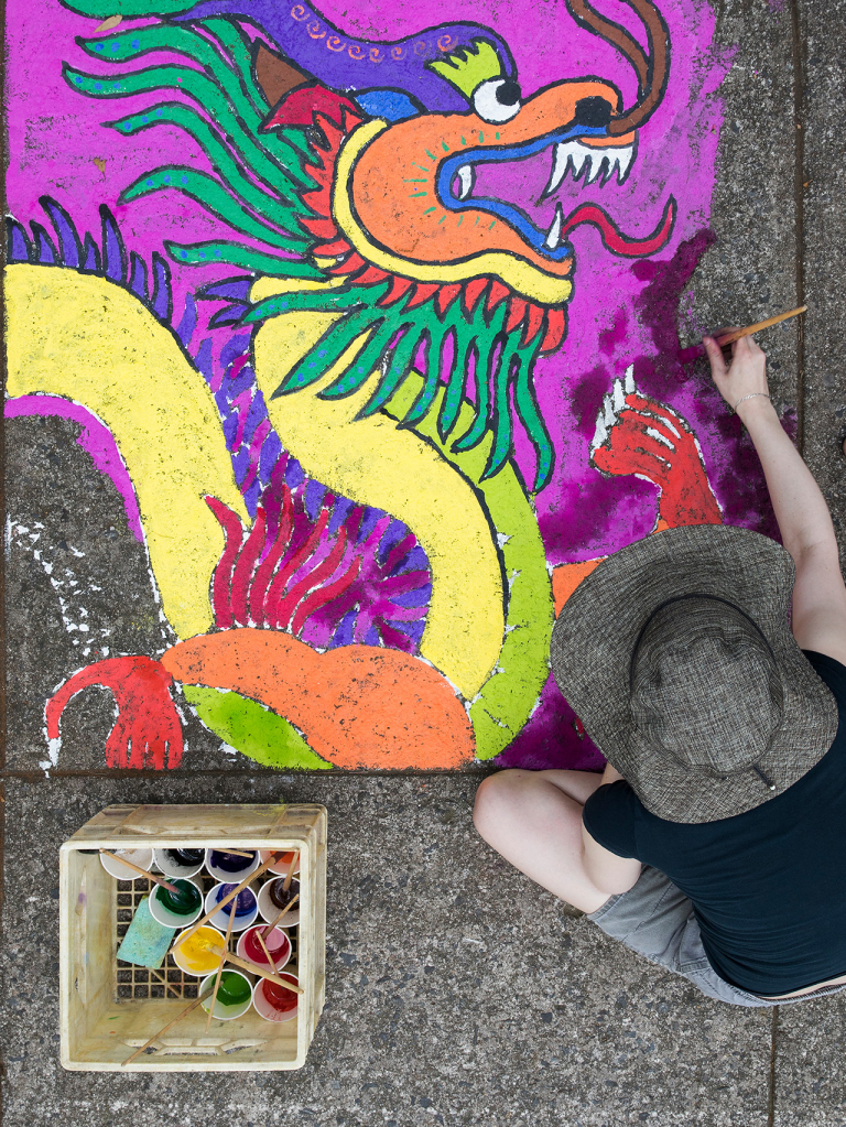 Student painting with chalk