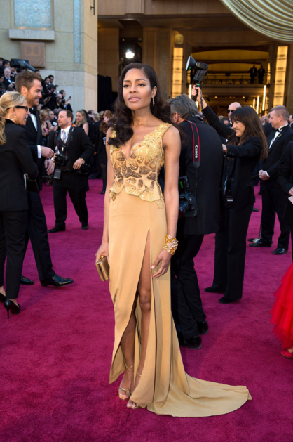 British actress and Bond Girl Naomie Harris wears a dress designed by SCAD Atlanta fashion student Michael Badger on the Oscar red carpet